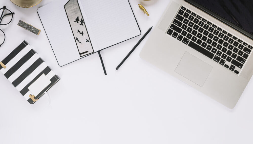 high-angle-view-laptop-stationeries-white-tabletop