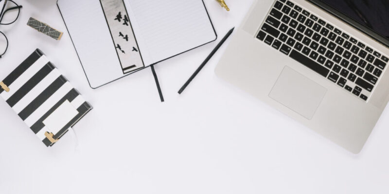high-angle-view-laptop-stationeries-white-tabletop